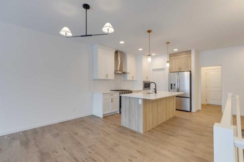 1402 Bayview Crescent Sw, Airdrie, AB - Indoor Photo Showing Kitchen With Upgraded Kitchen