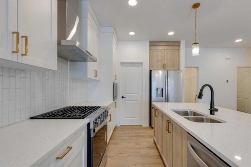 1402 Bayview Crescent Sw, Airdrie, AB - Indoor Photo Showing Kitchen With Double Sink With Upgraded Kitchen
