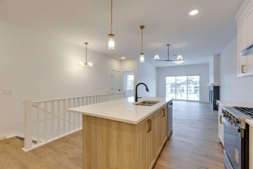 1402 Bayview Crescent Sw, Airdrie, AB - Indoor Photo Showing Kitchen With Double Sink With Upgraded Kitchen