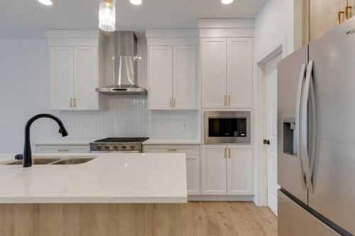 1402 Bayview Crescent Sw, Airdrie, AB - Indoor Photo Showing Kitchen With Double Sink