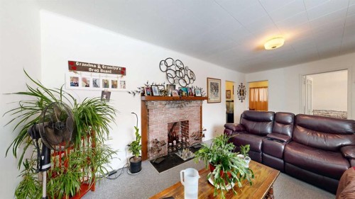 4716 51 Street, Stettler, AB - Indoor Photo Showing Living Room With Fireplace