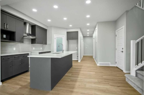 11 Heritage Link, Cochrane, AB - Indoor Photo Showing Kitchen With Upgraded Kitchen