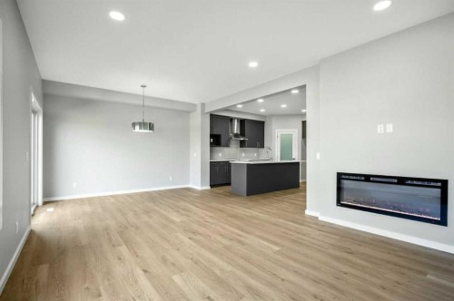 11 Heritage Link, Cochrane, AB - Indoor With Fireplace