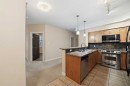 207-100 Lakeway Boulevard, Sylvan Lake, AB  - Indoor Photo Showing Kitchen With Stainless Steel Kitchen With Double Sink 