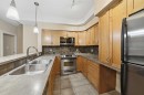 207-100 Lakeway Boulevard, Sylvan Lake, AB  - Indoor Photo Showing Kitchen With Stainless Steel Kitchen With Double Sink 