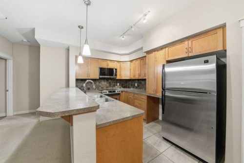 207-100 Lakeway Boulevard, Sylvan Lake, AB - Indoor Photo Showing Kitchen With Stainless Steel Kitchen With Double Sink