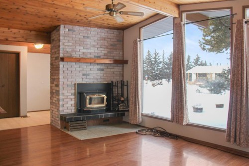 572 West Crescent, Forestburg, AB - Indoor Photo Showing Other Room With Fireplace