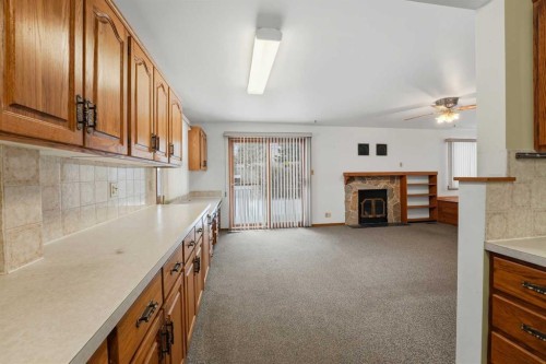 3927 Exeter Crescent, Red Deer, AB - Indoor Photo Showing Kitchen With Fireplace
