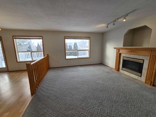 30 Logan Close, Red Deer, AB - Indoor Photo Showing Living Room With Fireplace
