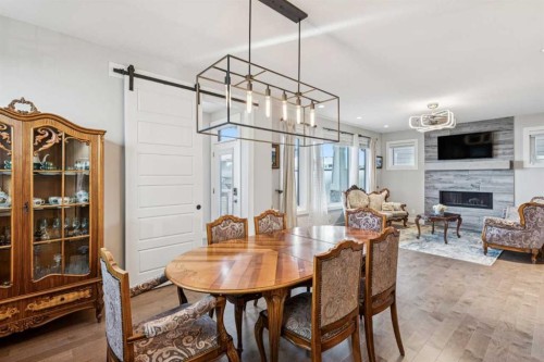 38 Yarrow Gate, Rural Rocky View County, AB - Indoor Photo Showing Dining Room With Fireplace