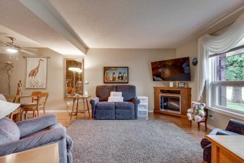 4313 46A Avenue, Red Deer, AB - Indoor Photo Showing Living Room With Fireplace