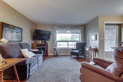 4313 46A Avenue, Red Deer, AB - Indoor Photo Showing Living Room With Fireplace
