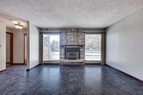 3 Armstrong Close, Red Deer, AB - Indoor Photo Showing Living Room With Fireplace