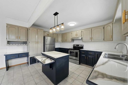 32 Huget Crescent, Red Deer, AB - Indoor Photo Showing Kitchen With Double Sink