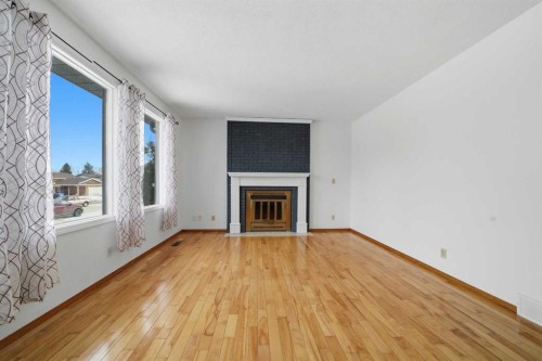 32 Huget Crescent, Red Deer, AB - Indoor Photo Showing Living Room With Fireplace