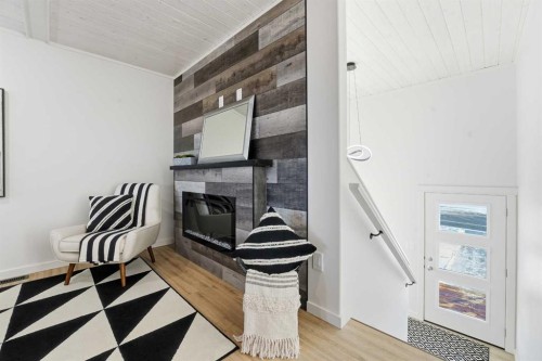 6 Metcalf Way, Lacombe, AB - Indoor Photo Showing Other Room With Fireplace