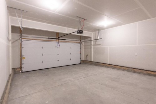 208 Augustus Way, Penhold, AB - Indoor Photo Showing Garage