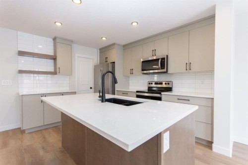 208 Augustus Way, Penhold, AB - Indoor Photo Showing Kitchen With Double Sink With Upgraded Kitchen