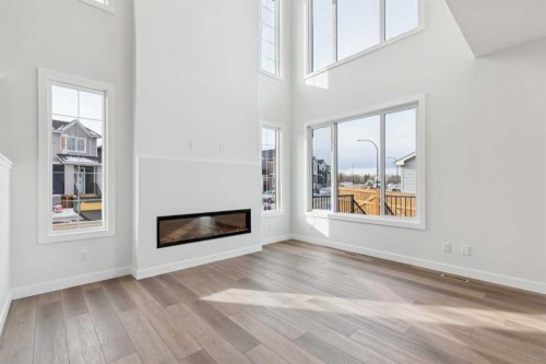 79 Versant Rise Sw, Calgary, AB - Indoor Photo Showing Living Room With Fireplace