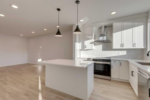 371 Fireside Drive, Cochrane, AB - Indoor Photo Showing Kitchen With Upgraded Kitchen