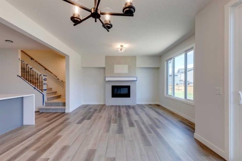 146 Northern Lights Crescent, Langdon, AB - Indoor Photo Showing Living Room With Fireplace