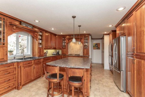 606 Pigeon Close, Pelican Point, AB - Indoor Photo Showing Kitchen With Double Sink