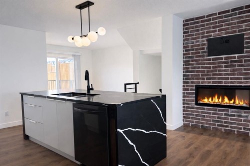 18 Violet Point, Sylvan Lake, AB - Indoor Photo Showing Kitchen With Fireplace With Double Sink