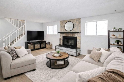 97 Cunningham Crescent, Red Deer, AB - Indoor Photo Showing Living Room With Fireplace