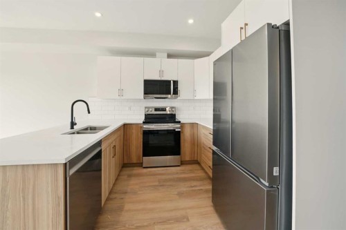 61 Pinnacle Close, Blackfalds, AB - Indoor Photo Showing Kitchen With Double Sink With Upgraded Kitchen