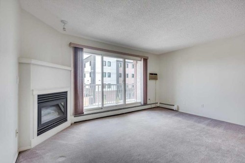 312-5330 47 Avenue, Red Deer, AB - Indoor With Fireplace