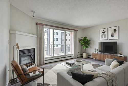 312-5330 47 Avenue, Red Deer, AB - Indoor Photo Showing Living Room With Fireplace