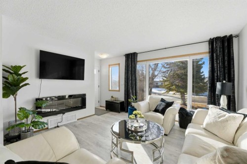 101 Erickson Drive, Red Deer, AB - Indoor Photo Showing Living Room With Fireplace