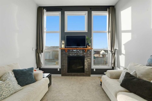 9 Sheep Close, Lacombe, AB - Indoor Photo Showing Living Room With Fireplace