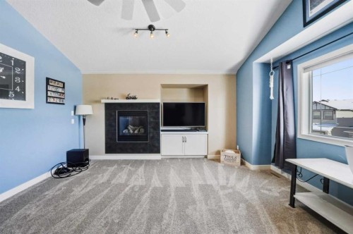 247 Kingston Way Se, Airdrie, AB - Indoor Photo Showing Living Room With Fireplace