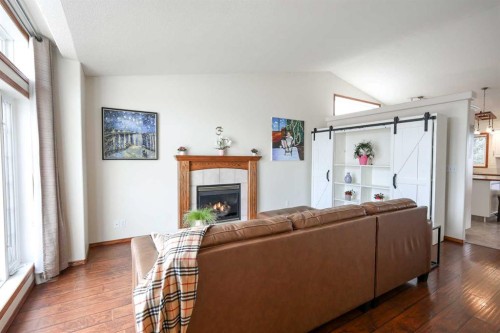 27 Falcon Crescent, Sylvan Lake, AB - Indoor Photo Showing Living Room With Fireplace