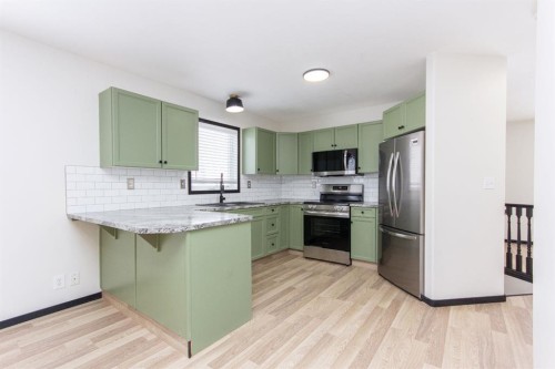 16 Johnson Close, Penhold, AB - Indoor Photo Showing Kitchen With Stainless Steel Kitchen With Upgraded Kitchen