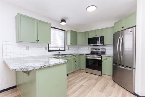 16 Johnson Close, Penhold, AB - Indoor Photo Showing Kitchen With Stainless Steel Kitchen