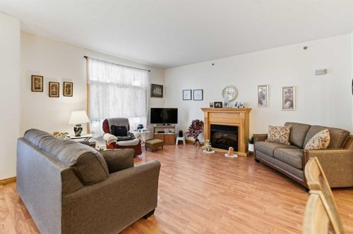 412-5213 61 Street, Red Deer, AB - Indoor Photo Showing Living Room With Fireplace