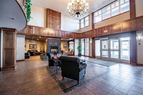 412-5213 61 Street, Red Deer, AB - Indoor Photo Showing Other Room With Fireplace