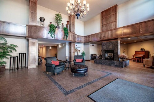 412-5213 61 Street, Red Deer, AB - Indoor Photo Showing Other Room With Fireplace