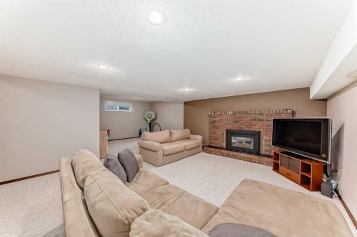 128 Dickenson Crescent, Red Deer, AB - Indoor Photo Showing Other Room With Fireplace