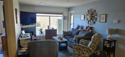 405-4425 Heritage Way, Lacombe, AB - Indoor Photo Showing Living Room With Fireplace