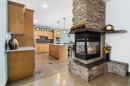 7 Laurel Road, Sylvan Lake, AB  - Indoor Photo Showing Kitchen With Fireplace 