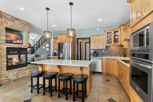 7 Laurel Road, Sylvan Lake, AB - Indoor Photo Showing Kitchen With Fireplace With Stainless Steel Kitchen With Upgraded Kitchen