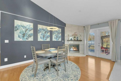 3905 39 Street Close, Ponoka, AB - Indoor Photo Showing Dining Room With Fireplace
