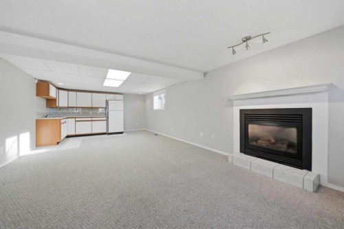 15 26534 Township Road 384, Rural Red Deer County, AB - Indoor Photo Showing Other Room With Fireplace