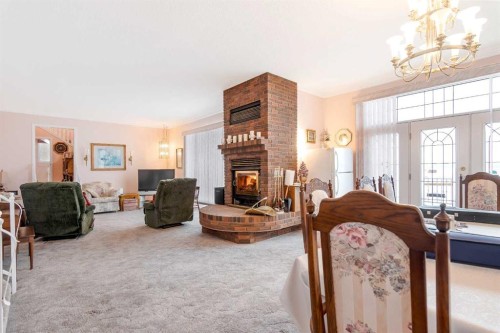 3 Rustic Road, Norglenwold, AB - Indoor With Fireplace