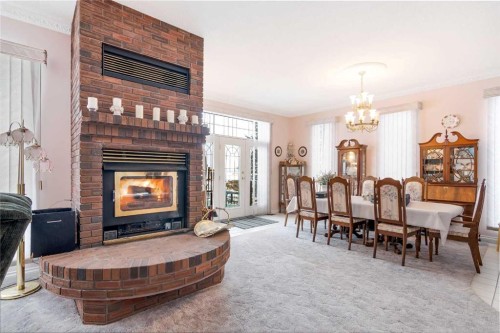 3 Rustic Road, Norglenwold, AB - Indoor With Fireplace