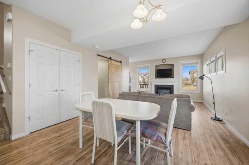 408-150 Vanier Drive, Red Deer, AB - Indoor Photo Showing Dining Room With Fireplace