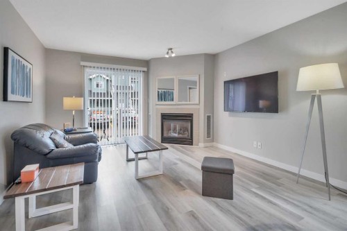 1212-5220 50A Avenue, Sylvan Lake, AB - Indoor Photo Showing Living Room With Fireplace